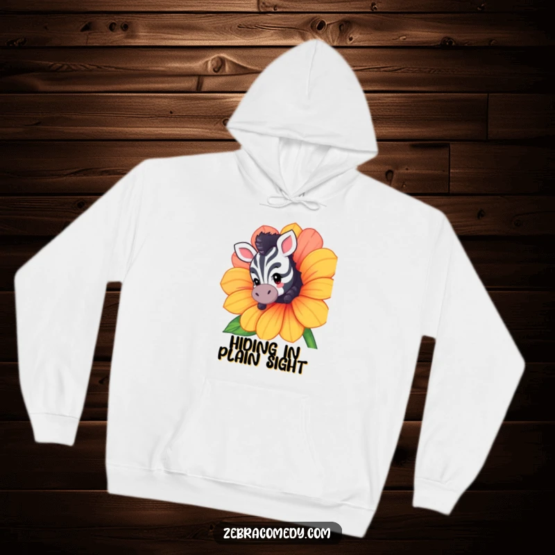 Funny hoodie featuring a curious zebra character peeking from behind a large flower, offering comfort and a dose of playful mystery.