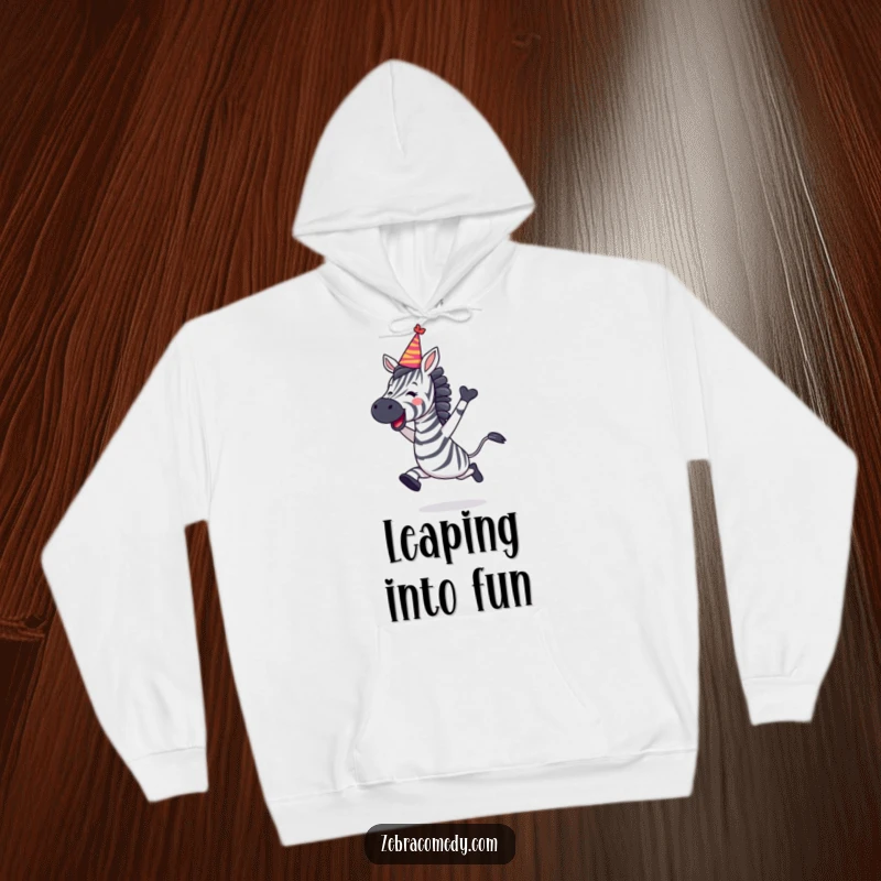 Funny Zebra Hoodie depicting a zebra leaping with joy, sporting a festive party hat, perfect for celebrations.