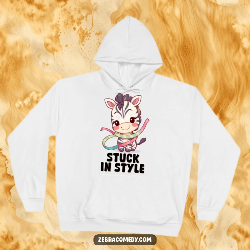 Funny hoodie with a smiling zebra character playfully tangled in a whimsical ribbon, offering cozy humor and style.