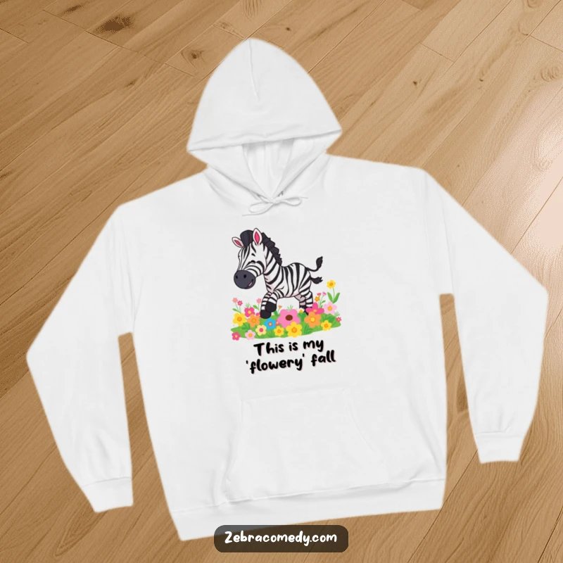 Funny hoodie showing a cartoon zebra slipping comically on a pile of colorful, blooming flowers, a playful design.